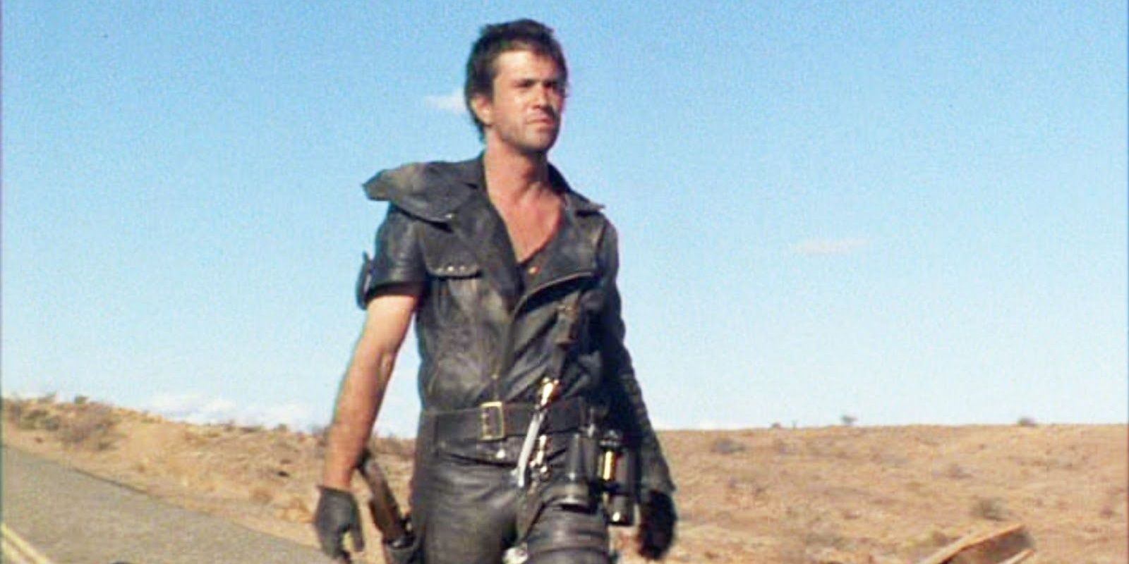 Mad Max standing in the middle of a wasteland in Mad Max 2