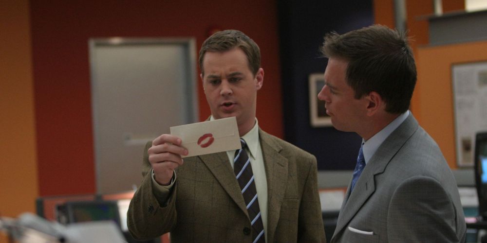 McGee and Tony look at a SWAK envelope in NCIS