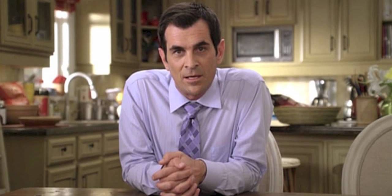 Phil Dunphy talking to camera in kitchen in Modern Family