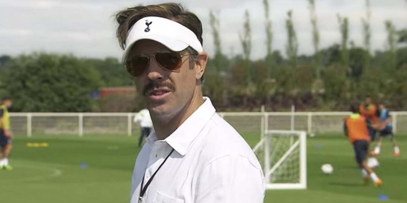 Ted Lasso in sunglasses and a visor on the pitch in Ted Lasso