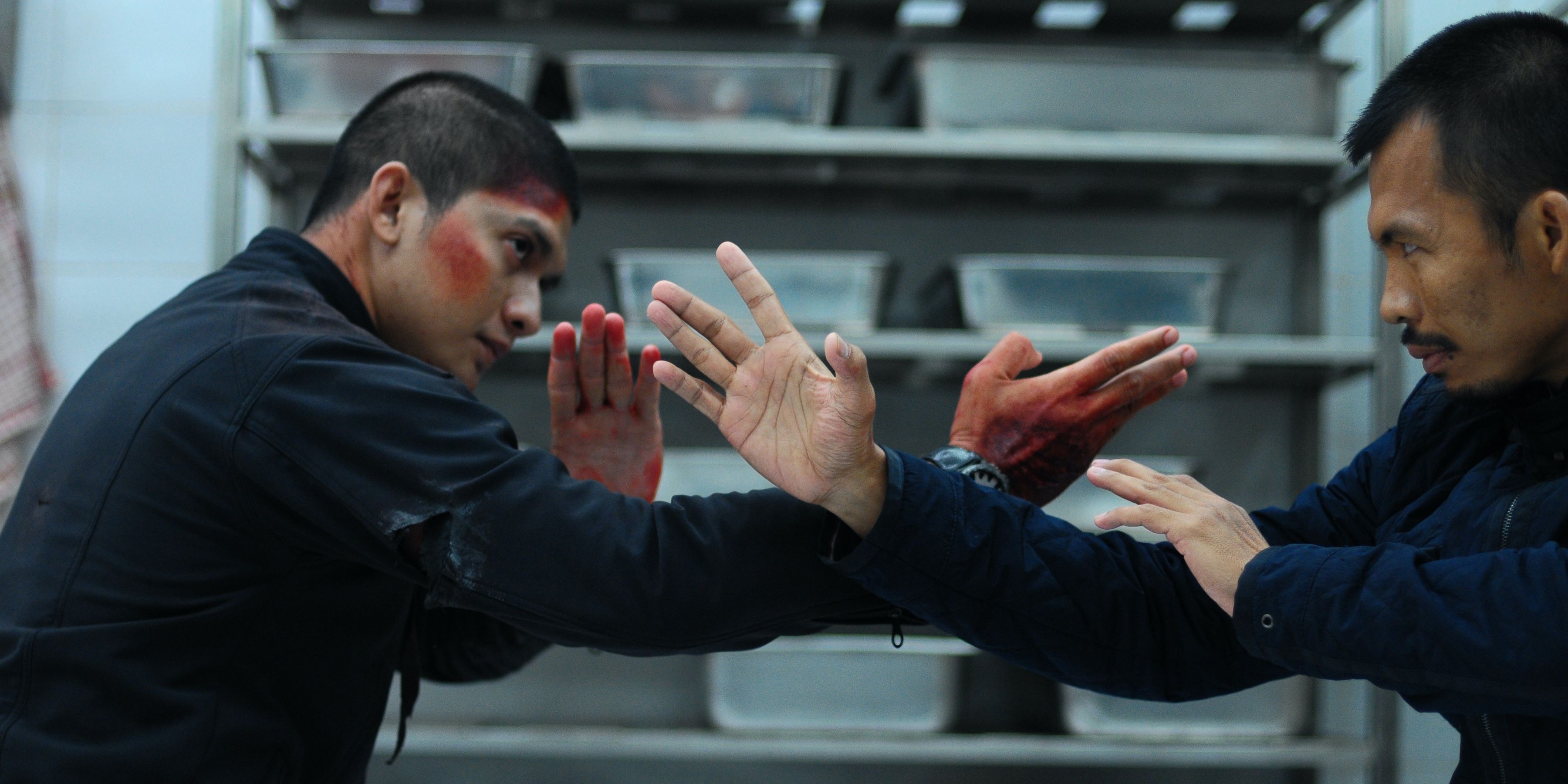 Two men covered in blood fight in Raid 2