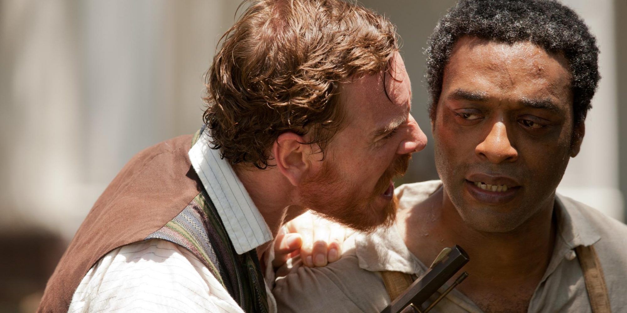 A slave master, Michael Fassbender, screams at a slave, Chiwetel Ejiofor in 12 Years a Slave