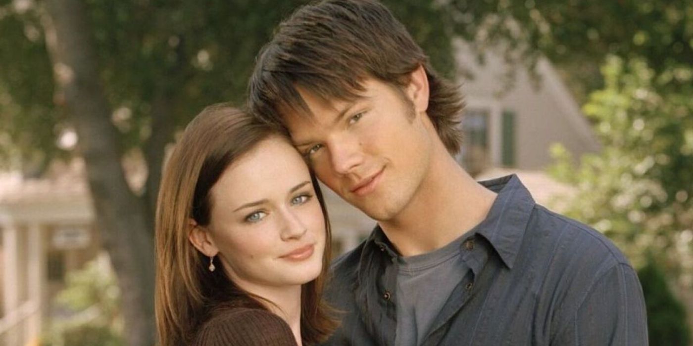 Rory and Dean smiling and facing the camera in a promotional image for Gilmore Girls