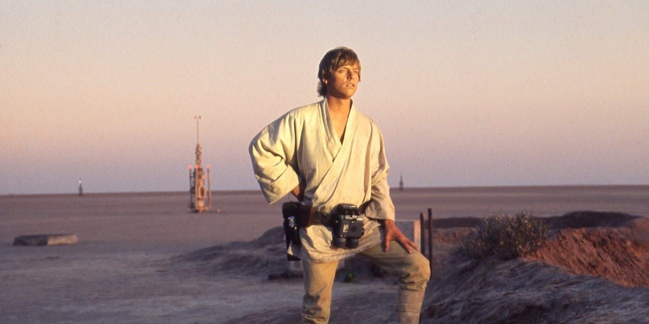 Luke Skywalker stands and looks at the sunset in Star Wars: Episode IV - A New Hope