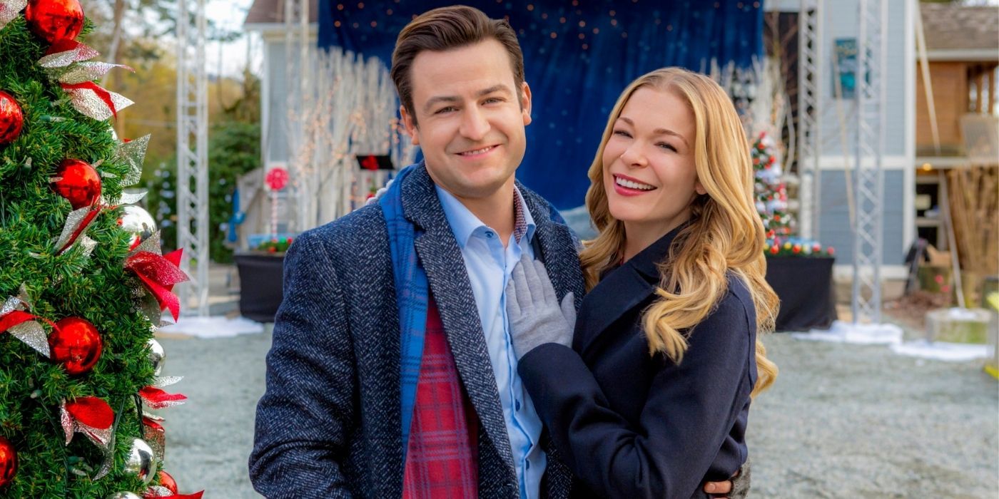 Liam and Eve stand with their arms around each other in It's Christmas Eve on Hallmark