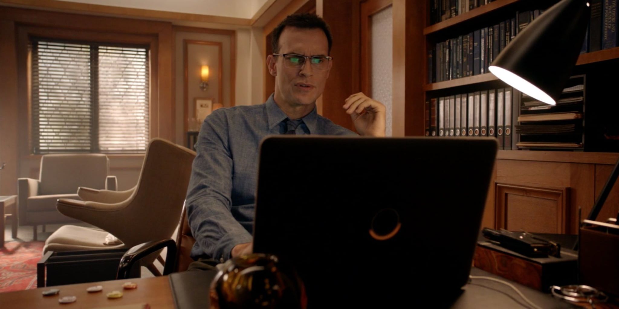 Rudy Vincent working on a computer in American Horror Story Cult
