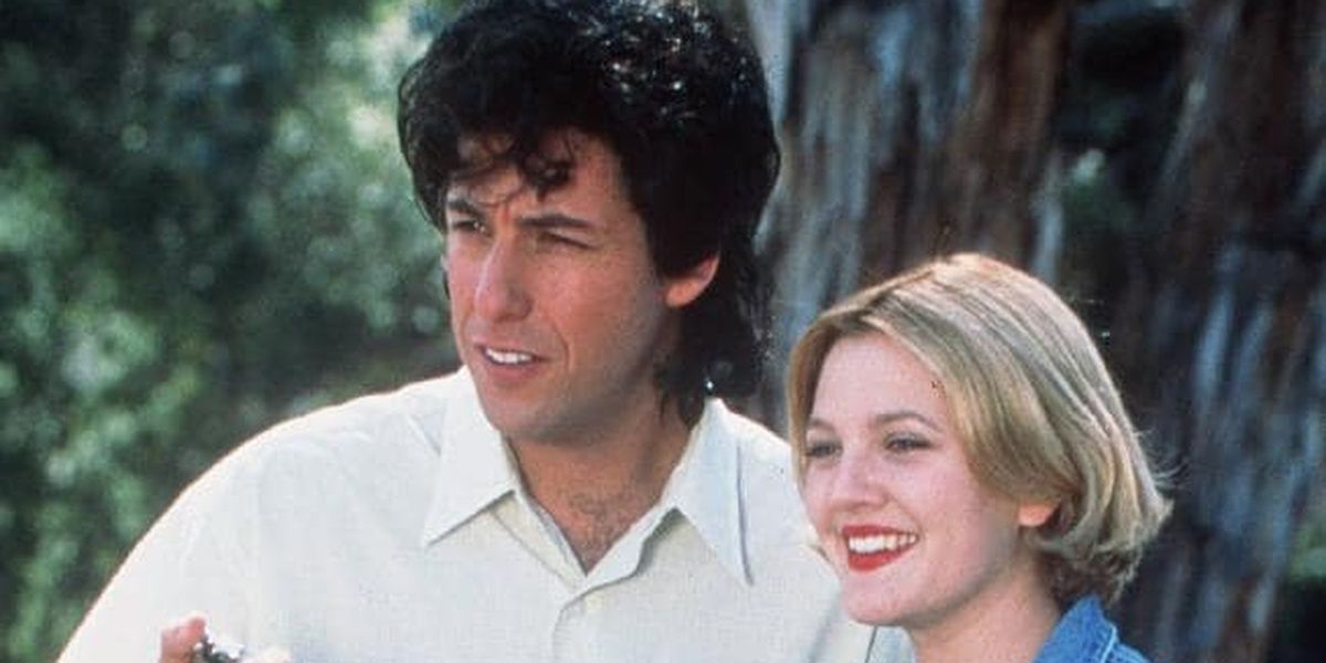 Adam Sandler and Drew Barrymore looking ahead and smiling in The Wedding Singer