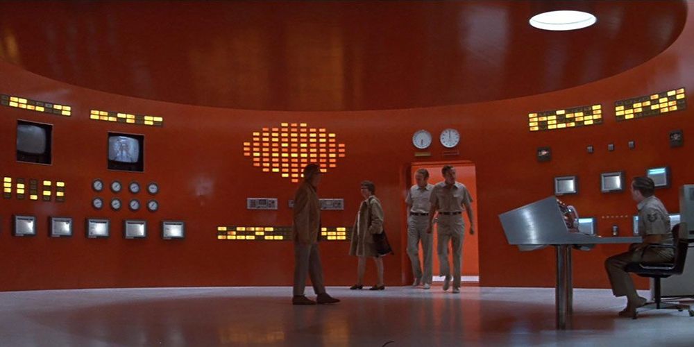 A group of people entering a red room full of strange technology in The Andromeda Strain.