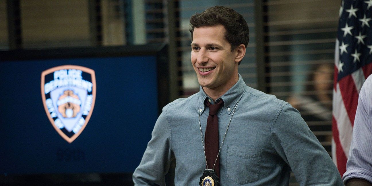 Jake Peralta smiling in the conference room in Brooklyn Nine-Nine