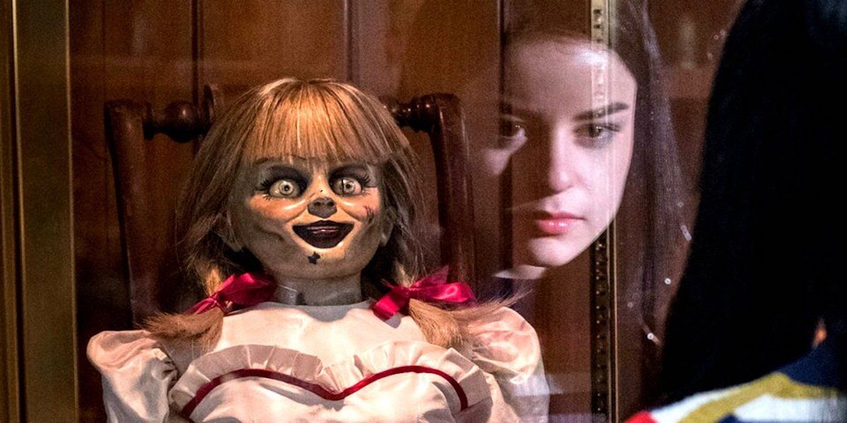 Judy's face reflected in Annabelle's case in Annabelle Comes Home (2019)
