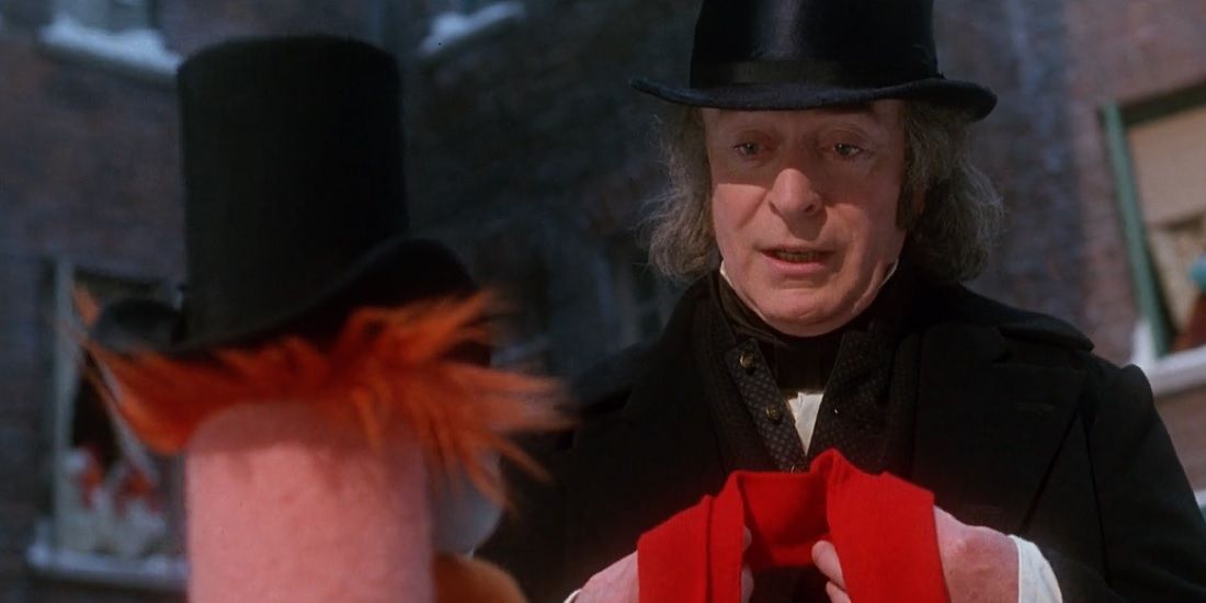 Beaker gives Scrooge his scarf in The Muppet Christmas Carol