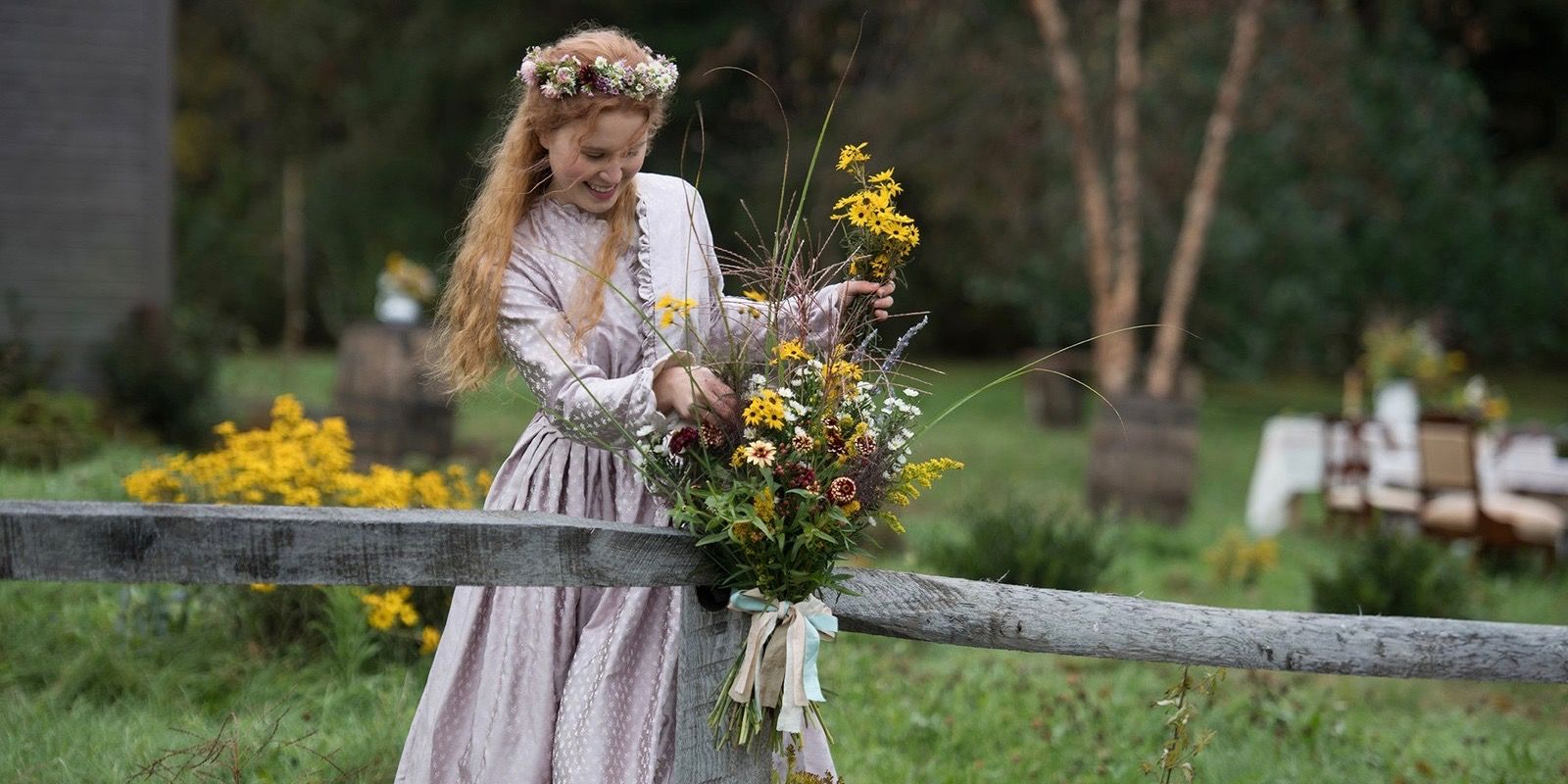 Beth March arranging flowers on a fence post in Little Women