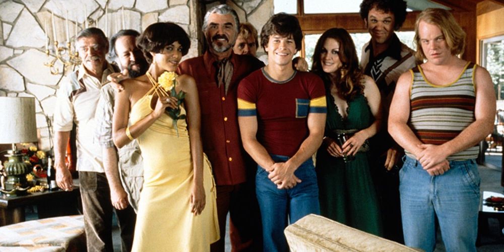 The characters group together for a family photo in Boogie Nights