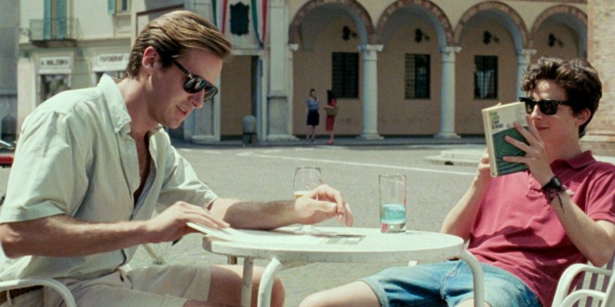 Oliver and Elio sitting together in a piazza in Call Me By Your Name.
