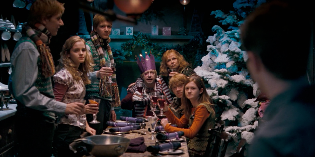 Harry looks at the Weasley's as they sit for Christmas dinner in Harry Potter And The Order Of The Phoenix Cropped