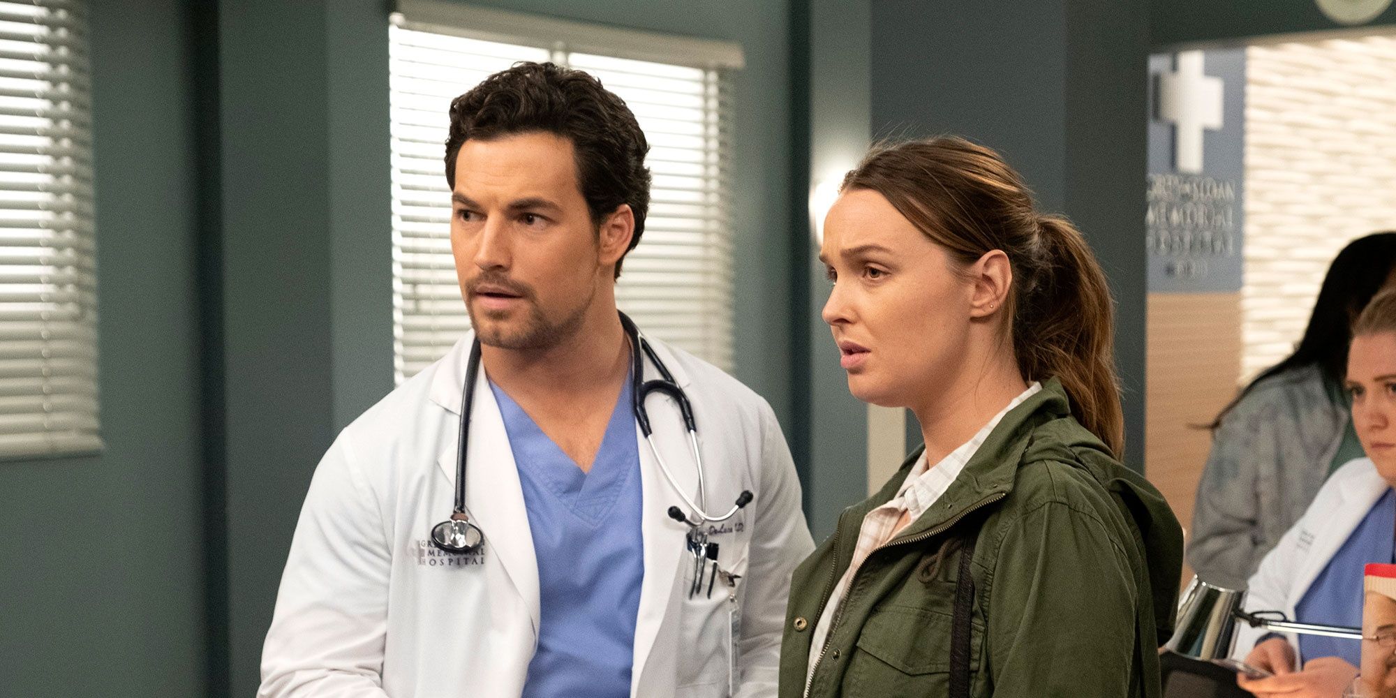 An image of Jo and DeLuca standing in the hallway in Grey's Anatomy