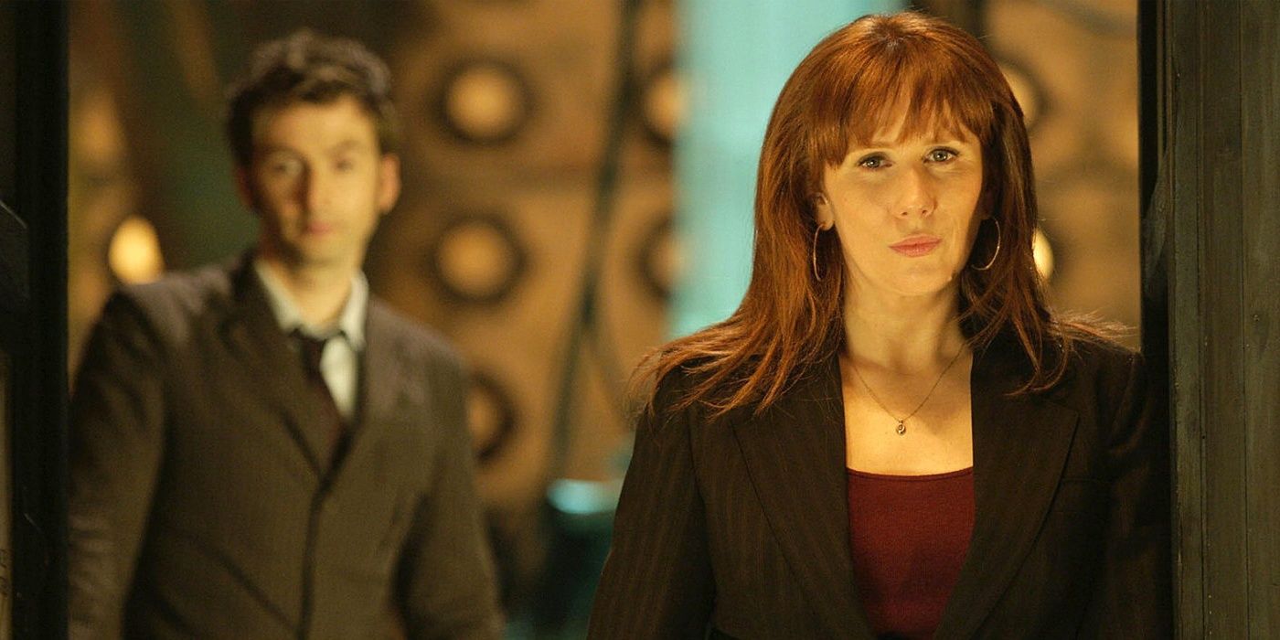 Donna Noble stands in the TARDIS with the Tenth Doctor in the background in an episode of Doctor Who.