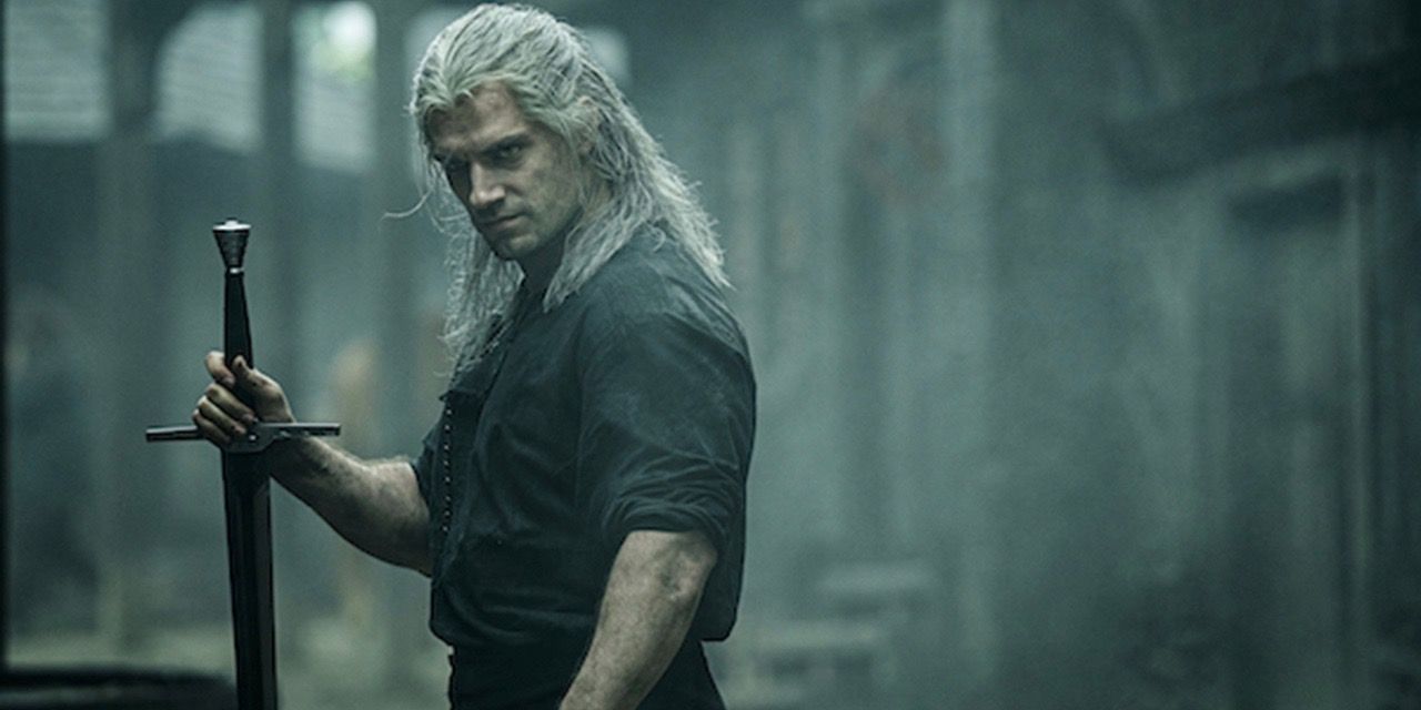 Geralt of Rivia holding his sword in Blaviken from The Witcher Season 1