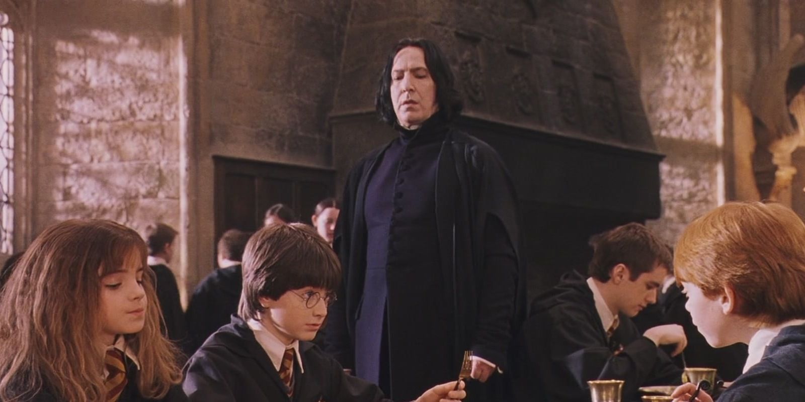 Harry, Hermione and Ron in the Great Hall with Snape looking at Harry