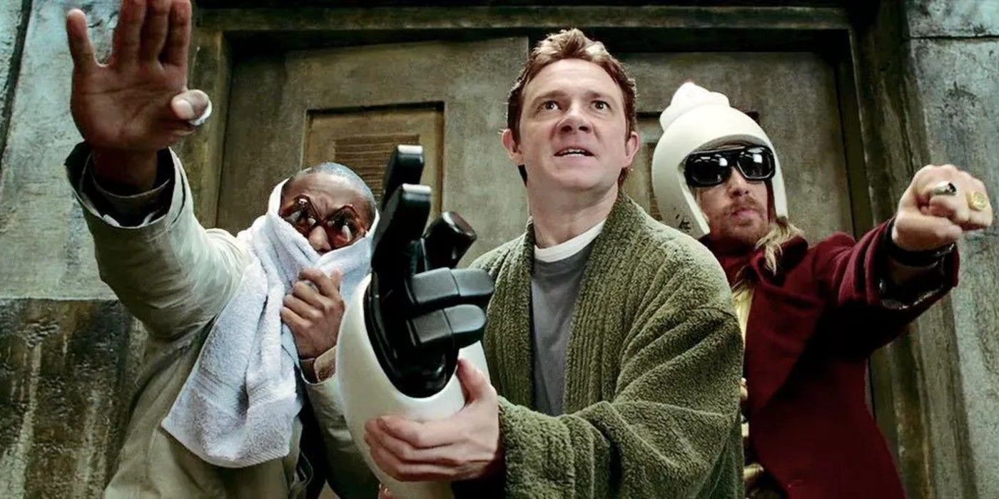 Arthur Dent holding a robot hand in The Hitchhiker's Guide To The Galaxy