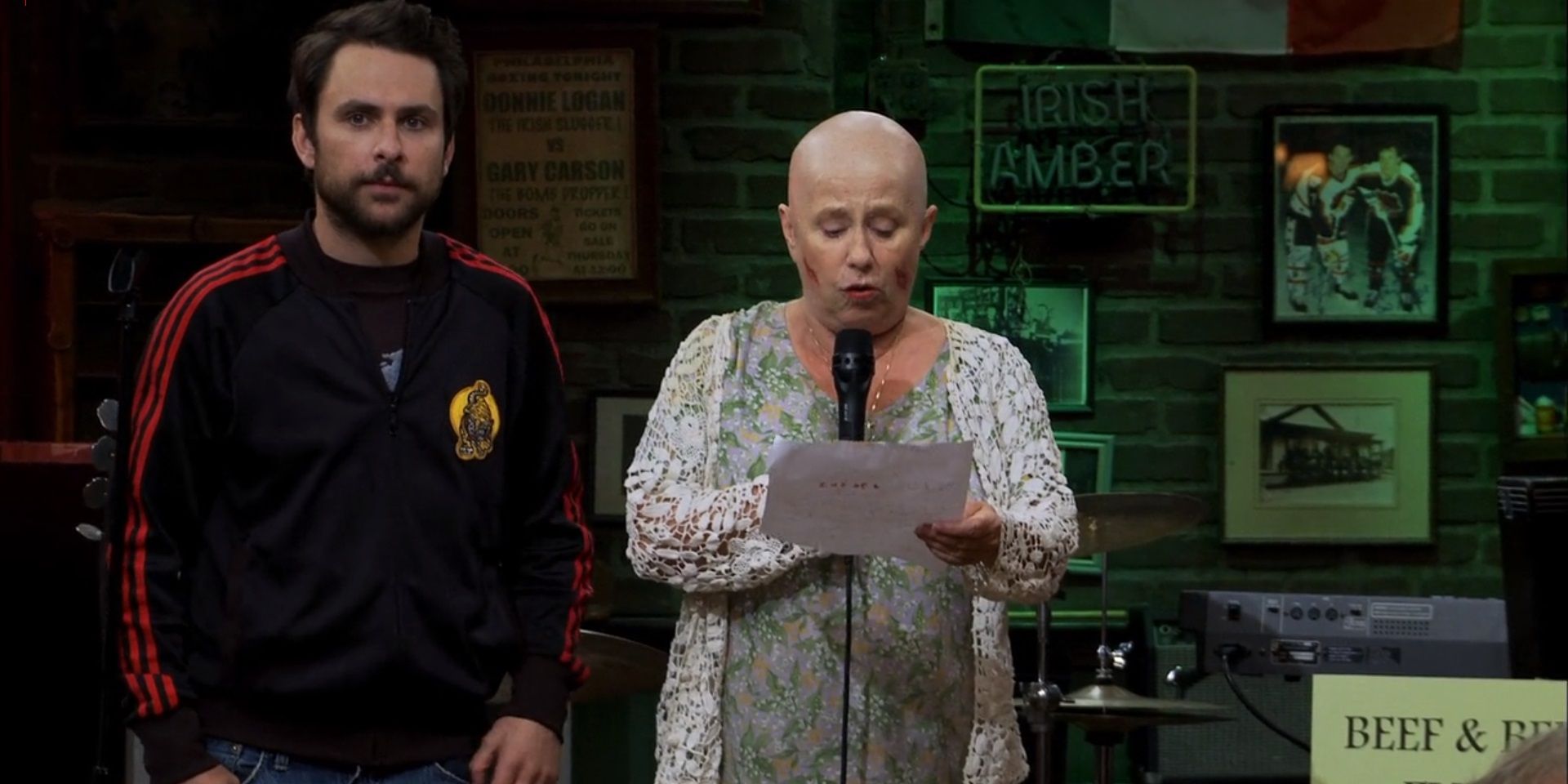 Bonnie reading her speech as Charlie stands next to her in It's Always Sunny in Philadelphia.