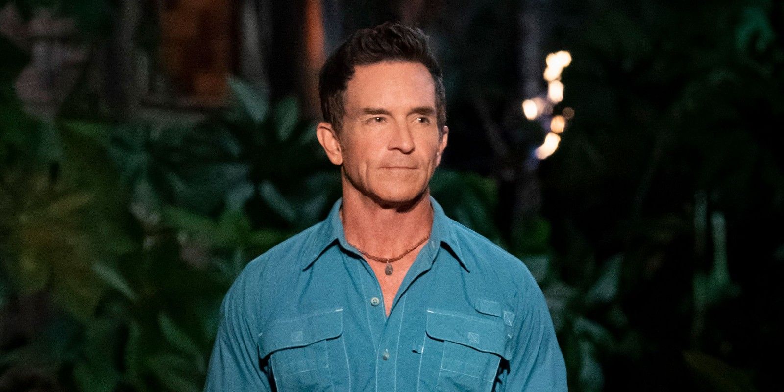 Survivor Jeff Probst wearing blue shirt serious expression at tribal council
