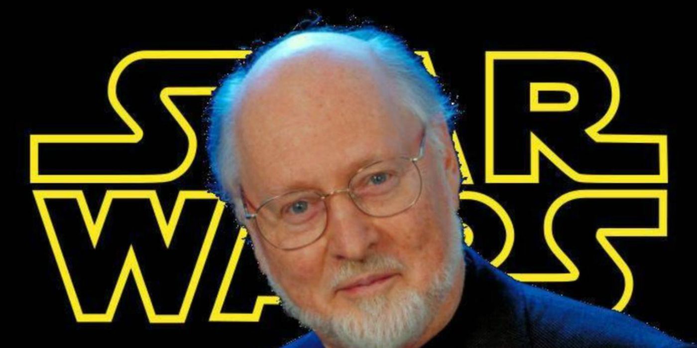 John Williams with the Star Wars logo in the background