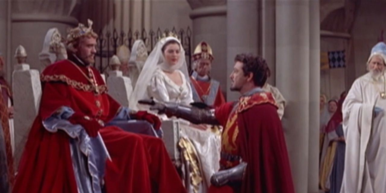 Arthur on his throne with someone kneeling before him in Knight of the Round Table