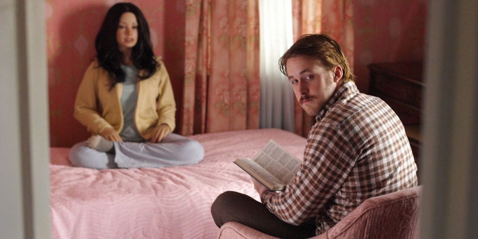 Ryan Gosling with Bianca on a bed in Lars and the Real Girl