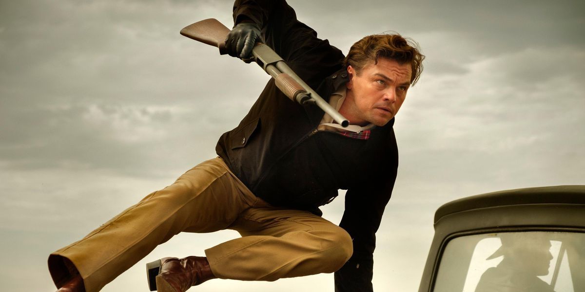 Leonardo DiCaprio leaps from a truck with a gun in his hand from Once Upon A Time In Hollywood