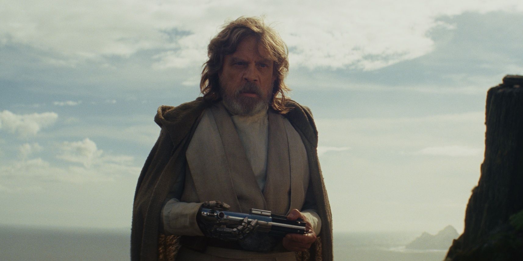 Luke holding his lightsaber in Star Wars The Last Jedi
