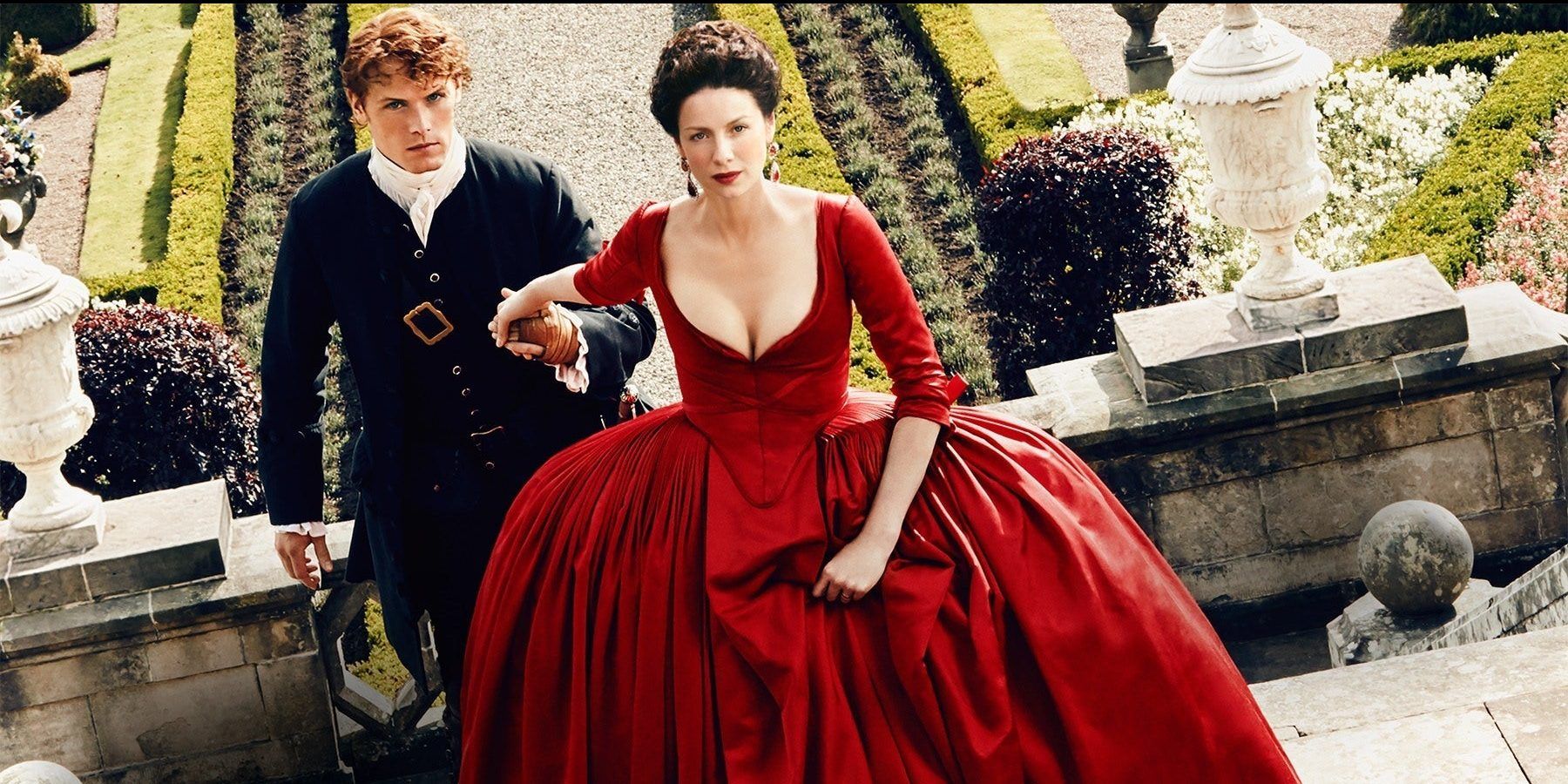 Outlander's Claire walks up steps in a red dress. 