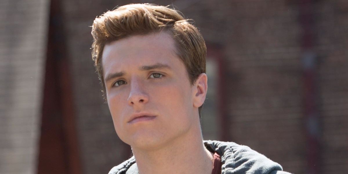Peeta Mellark from The Hunger Games looks into the distance.