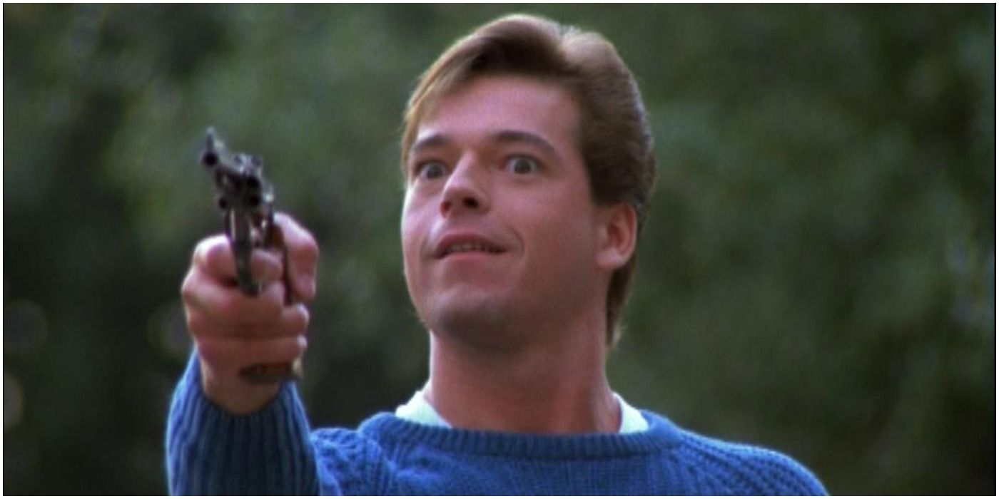 Ricky pointing a gun and smiling in Silent Night Deadly Night 2