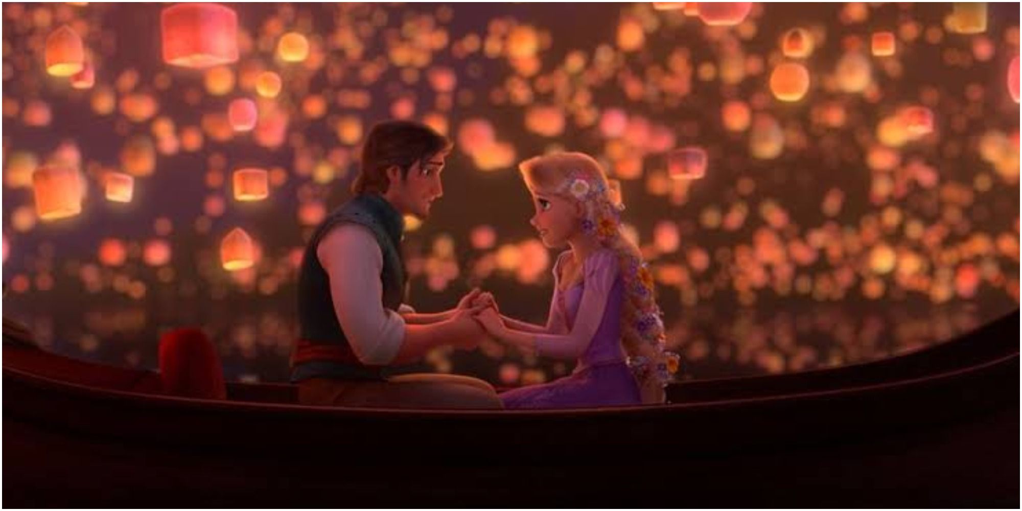 Flynn and Rapunzel in the boat surrounded by lanterns in Tangled