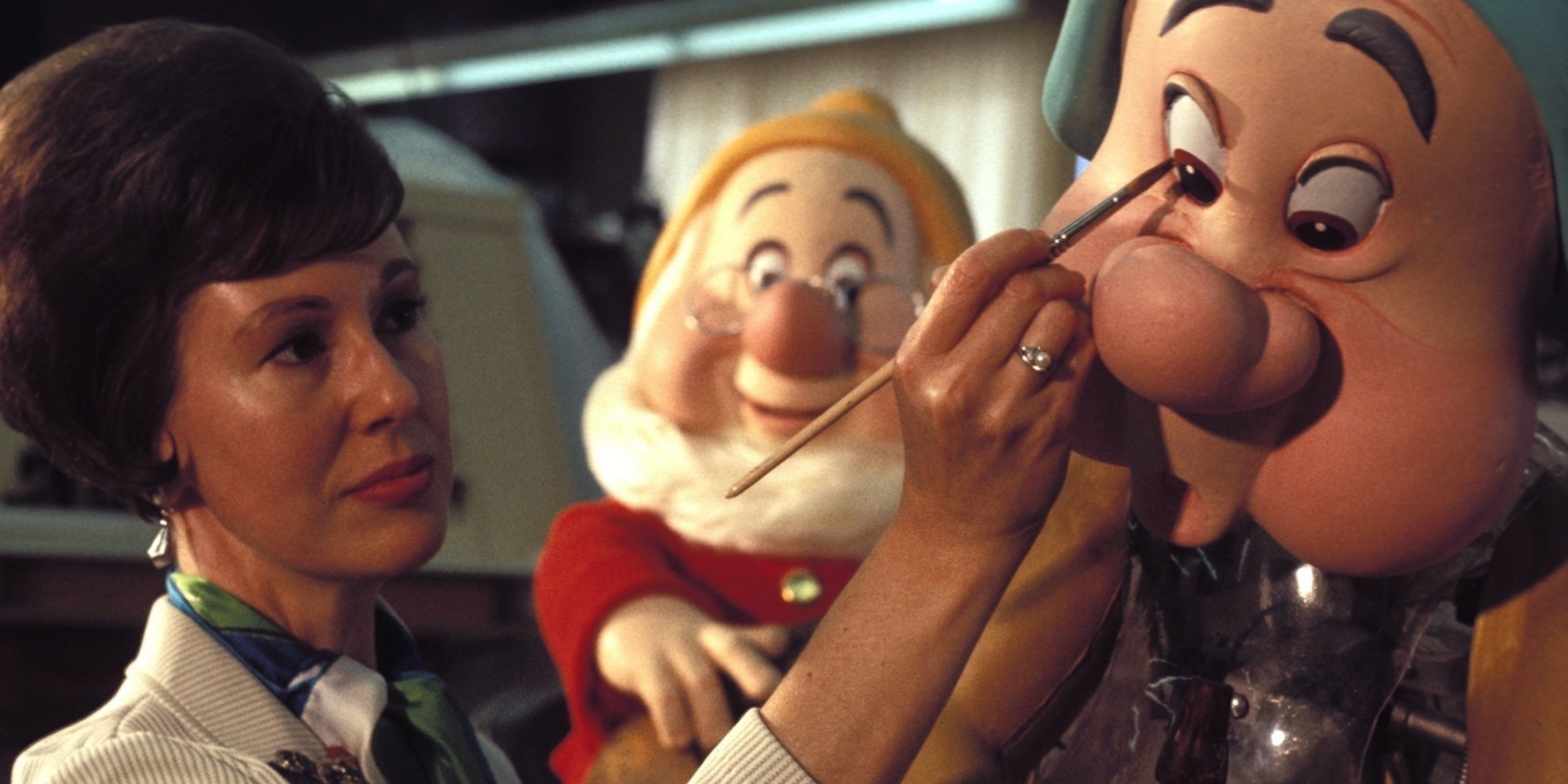 An Imagineer painting an animatronic in The Imagineering Story.