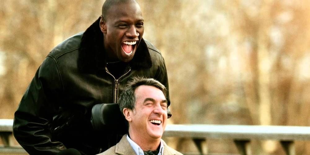 Scene from the Intouchables with two main characters laughing outside.
