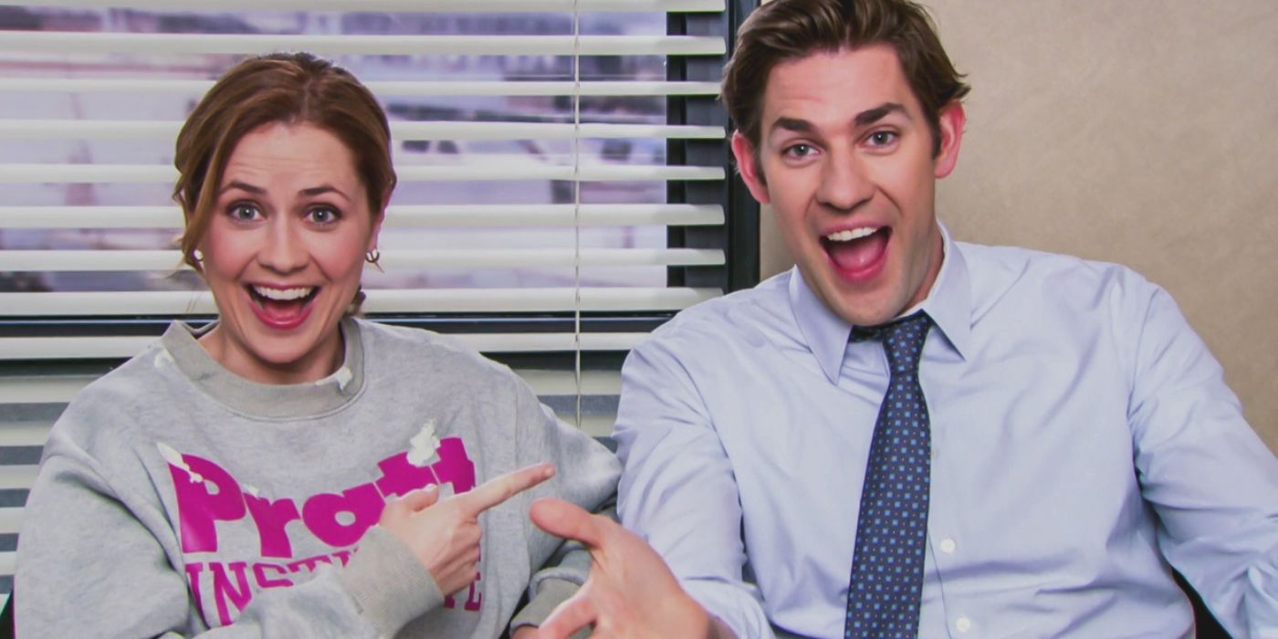 Pam points at Jim as they both laugh in The Office