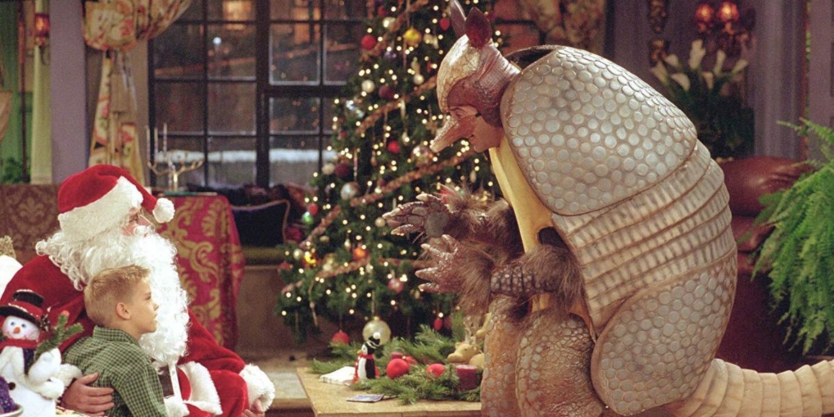 Ben sitting with Chandler dressed as Santa Claus and Ross as the Holiday Armadillo at Monica's in Friends. 