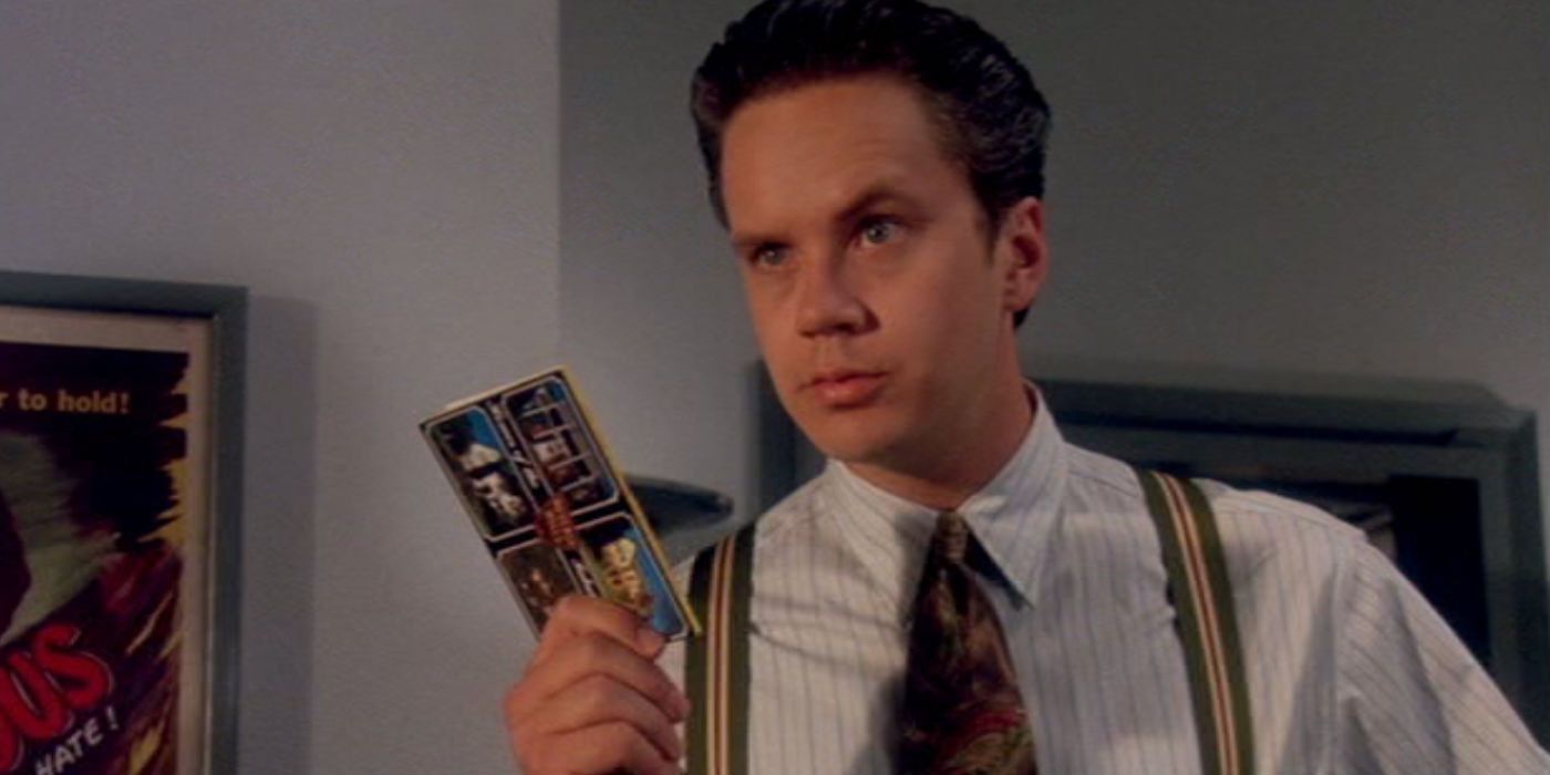 Griffin holds up a postcard in The Player