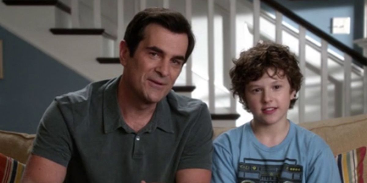 Phil and Luke sitting on the couch on Modern Family