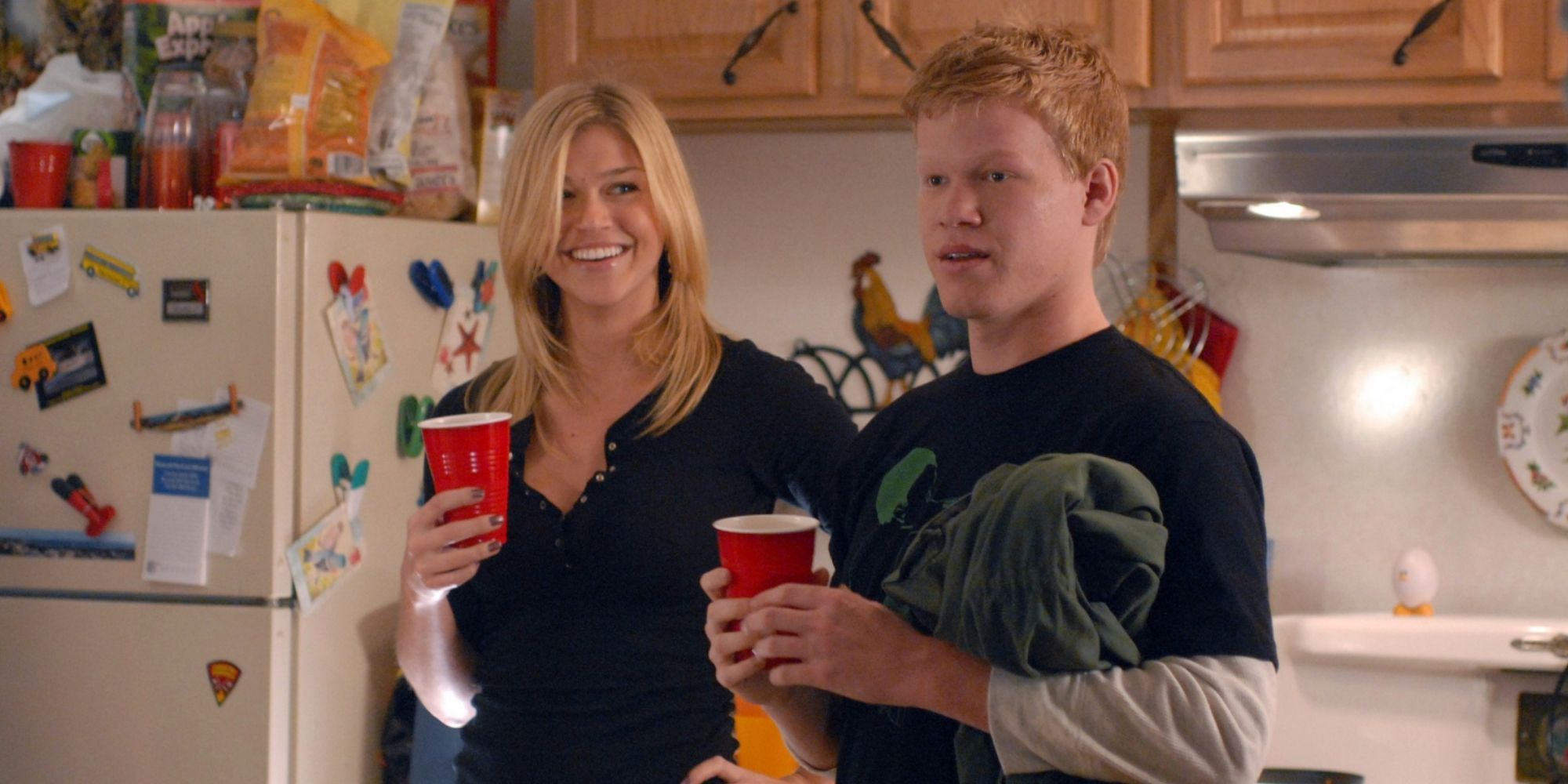 Tyra and Landry stand together in a kitchen at a party in Friday Night Lights
