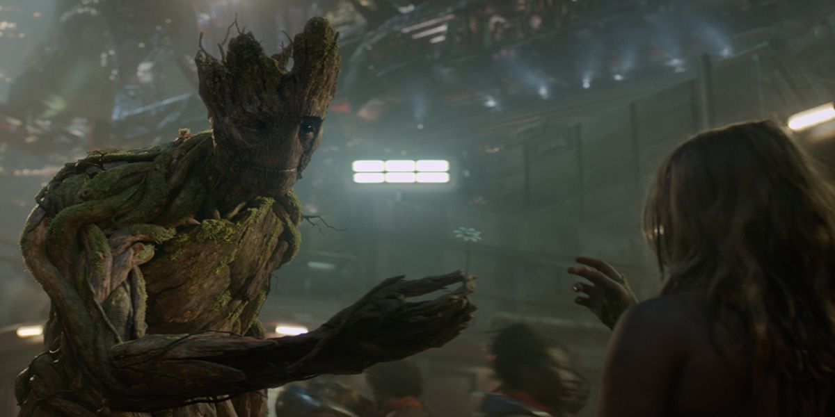 Groot gives a child a flower in Guardians of the Galaxy