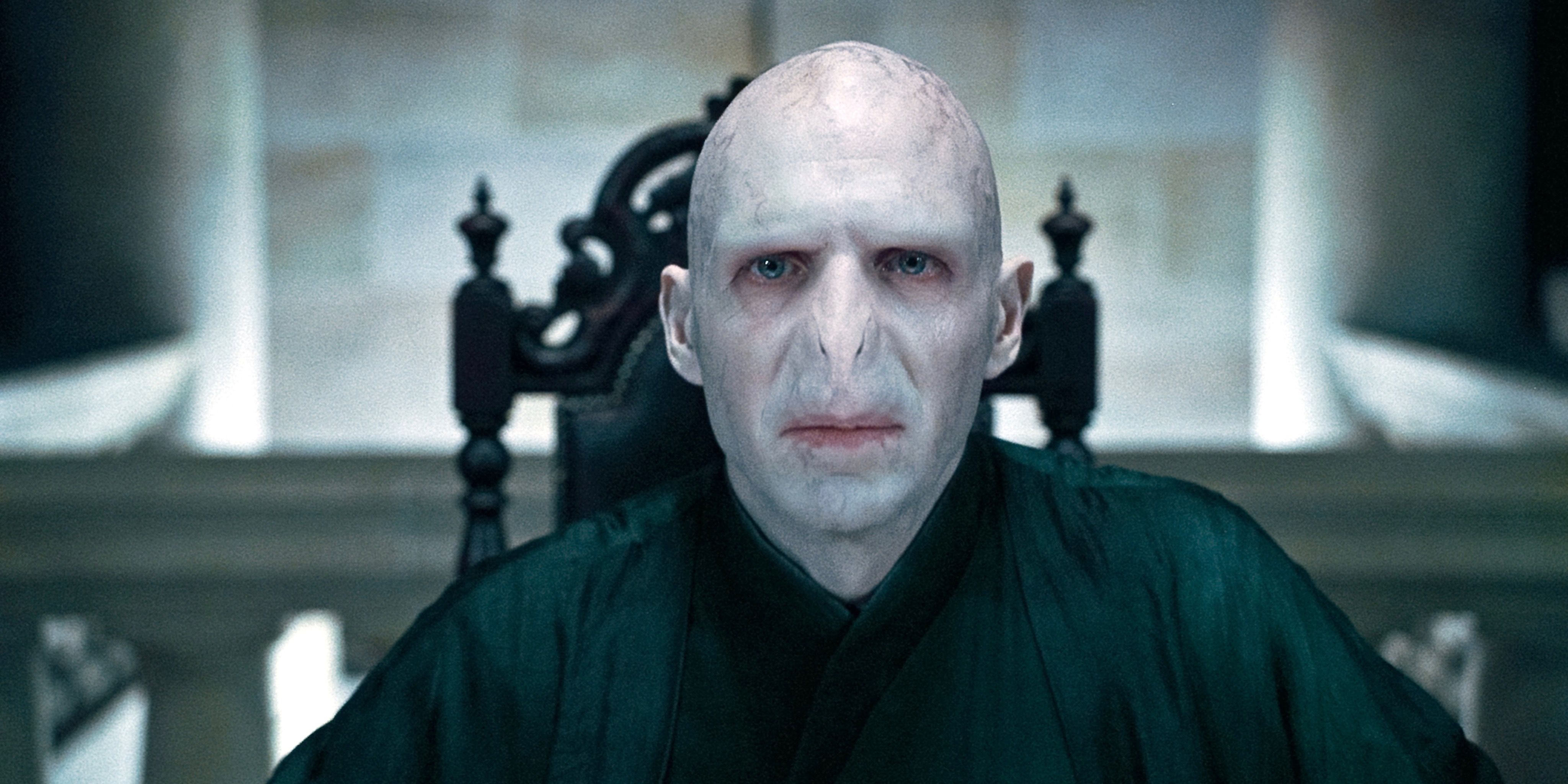 Voldemort sitting at the head of a table in Deathly Hallows Part 1.