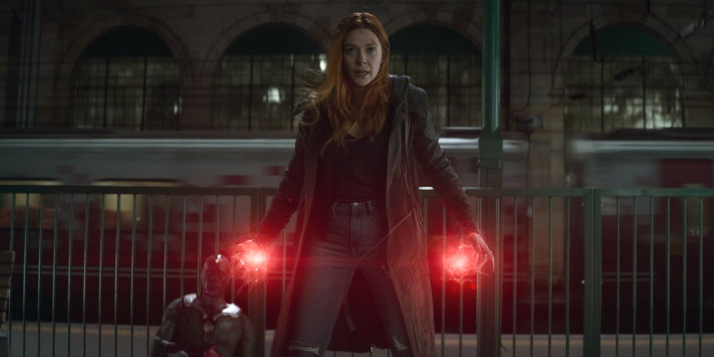 Wanda Maximoff stands in front of Vision with glowing hands in Avengers: Infinity War