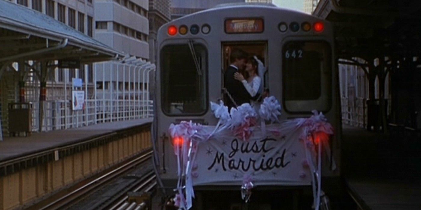 Jack (Bill Pullman) and Lucy (Sandra Bullock) kissing in the back of a subway with a &ldquo;Just Married&rdquo; sign in While You Were Sleeping.