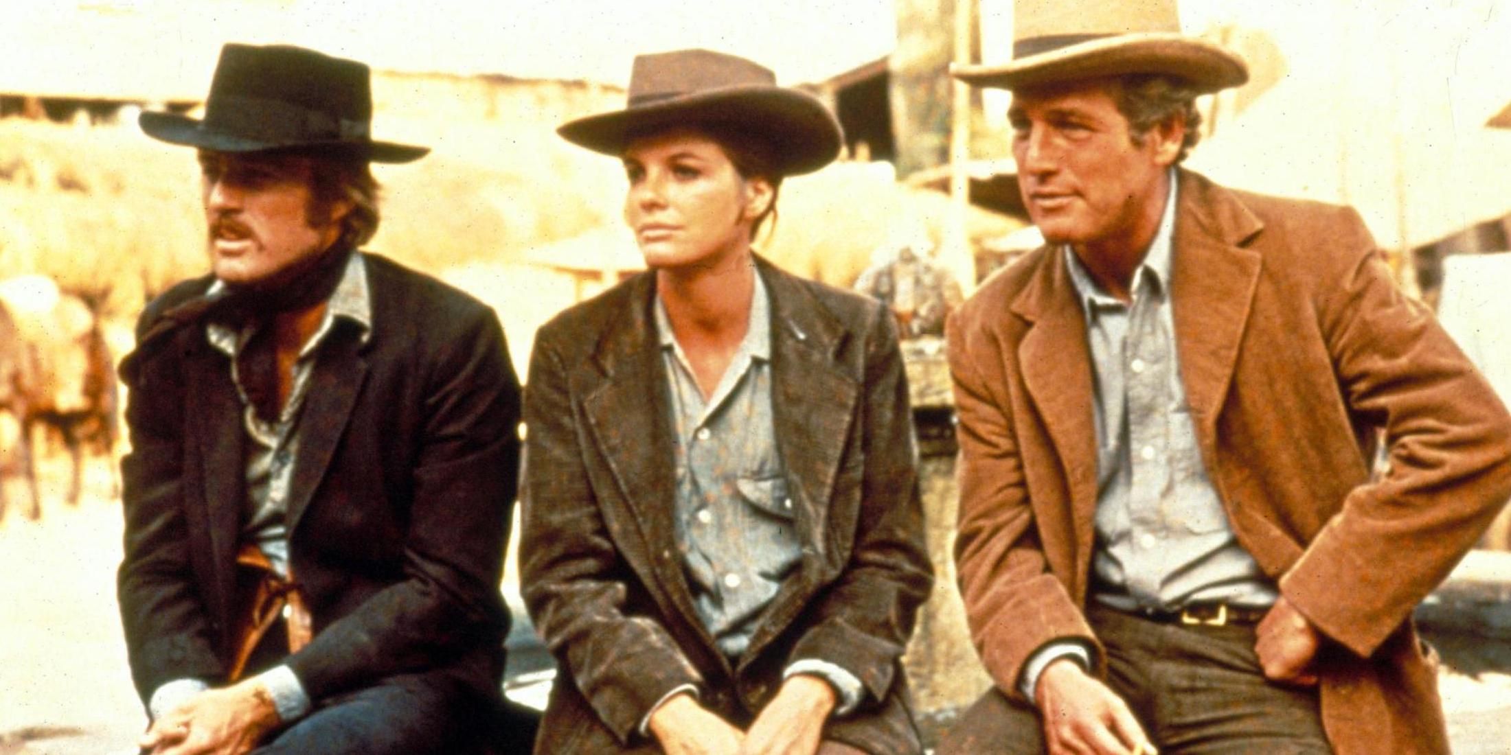 Paul Newman, Robert Redford, and Katharine Ross sitting side by side in Butch Cassidy and the Sundance Kid