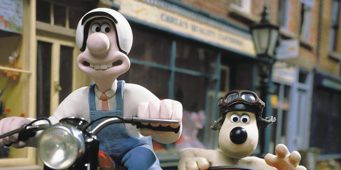 Wallace riding a motorcycle while Gromit sits in the sidecar in a still from A Close Shave