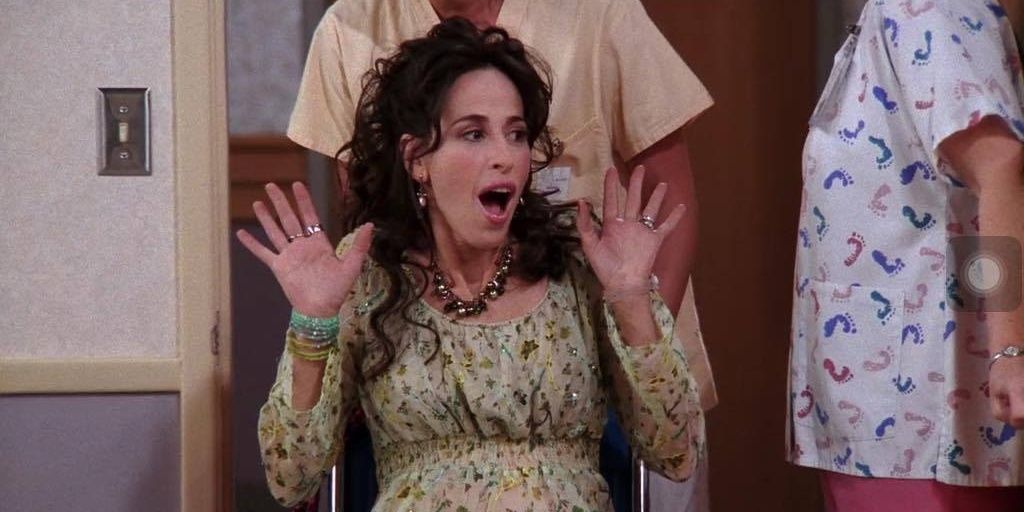 Pregnant Janice in a wheelchair at a hospital in Friends.