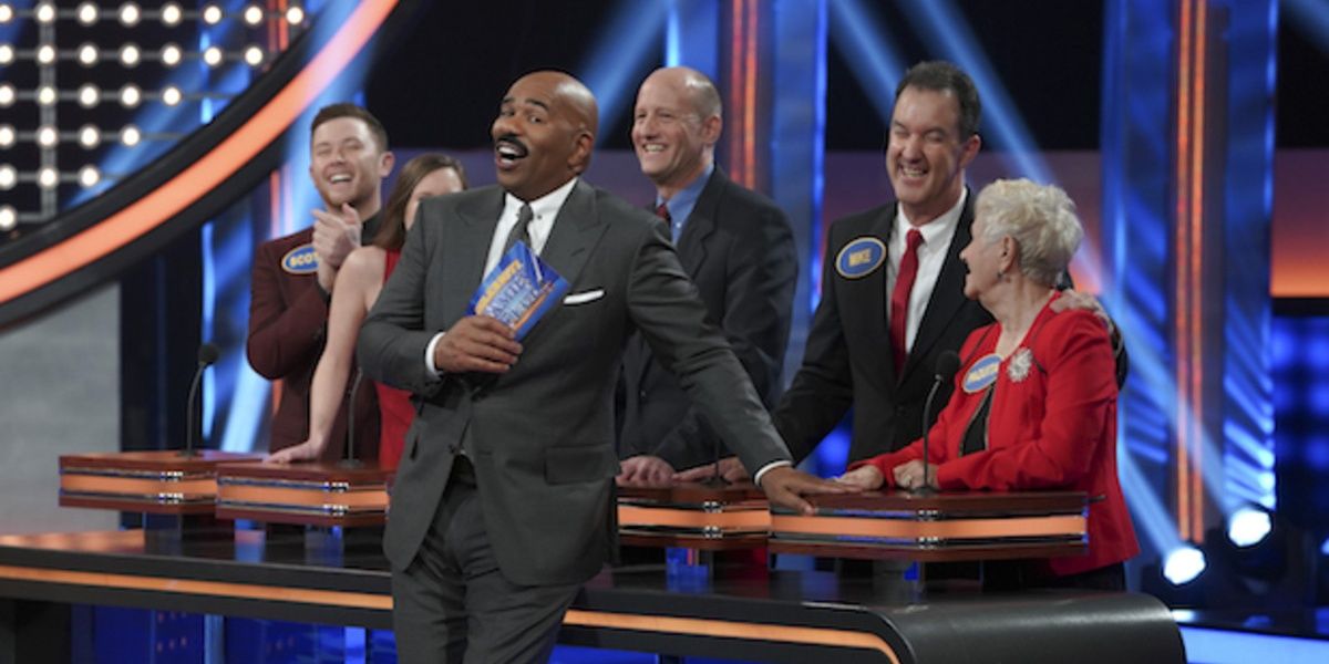 Steve Harvey reacts with his back to the contestants on Family Feud